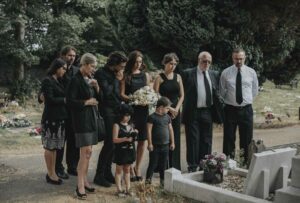 family giving their last goodbyes at the cemetery