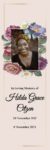 Memorial card with floral border and smiling woman.