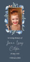 Memorial card with floral border and smiling woman.