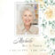 Memorial card with smiling elderly woman and flowers.