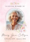 Memorial portrait of smiling elderly woman with flowers.