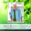 Smiling elderly man in kitchen, green leaf background.