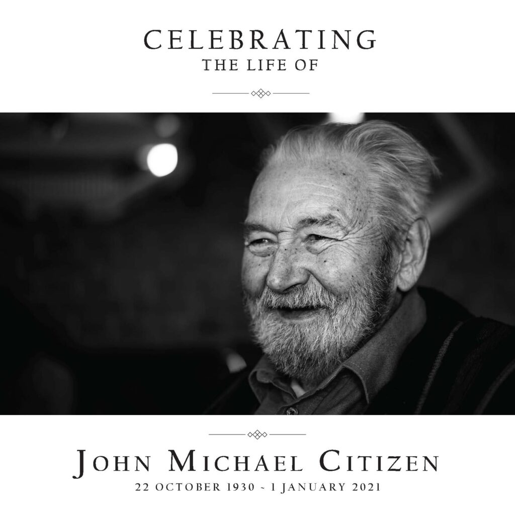 Memorial portrait of an elderly smiling man.